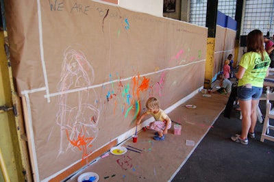 In 2010, the Dumbo Arts Festival changed its format and debuted a new slate of family-minded activities and entertainment. To encourage the participation of all-ages guests, the festival programming included a painting station where folks could express themselves freely.