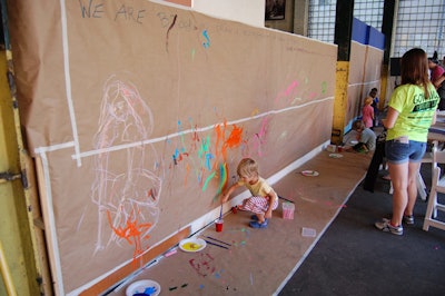 In 2010, the Dumbo Arts Festival changed its format and debuted a new slate of family-minded activities and entertainment. To encourage the participation of all-ages guests, the festival programming included a painting station where folks could express themselves freely.