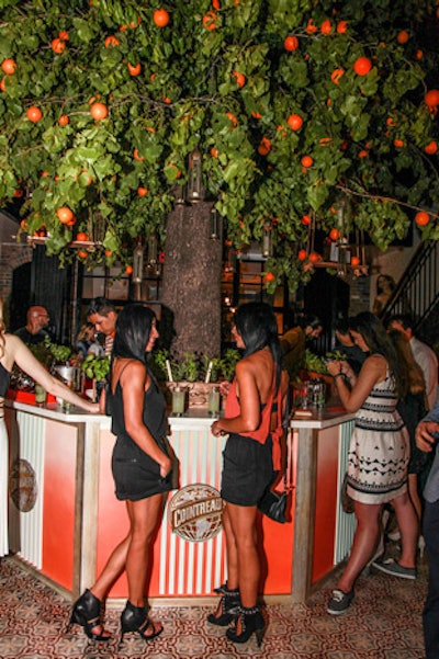 The open atrium patio within the Broome Hotel allowed event producer BMF Media to erect a faux 28-foot-tall orange tree that served as the event's centerpiece.