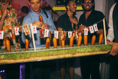 Riviera Caterers served carnival-inspired fare. Items included corn dogs served in long, grassy trays with packages of ketchup and mustard strung overhead.