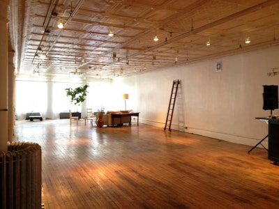 Tin ceiling, hard woods floors, white walls, eastern and western natural light