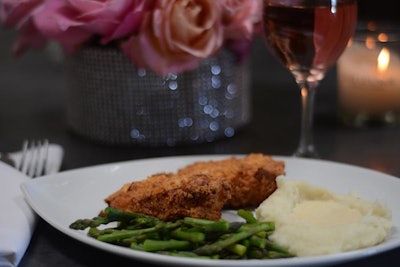 A crispy chicken entree served with green beans, mashed potatoes, and gravy.