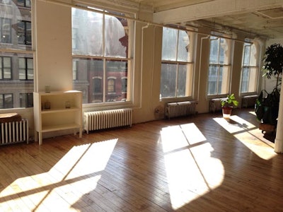 Eastern and western natural light loft original hard wood floors and white walls