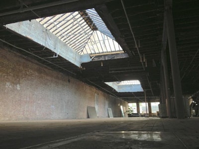 Raw 20 x12 skylights with natural daylight exposed brick walls dark hard wood floors