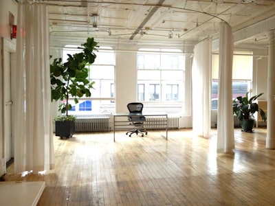 Open floor plan hard wood floors, white walls semi furnished soho loft