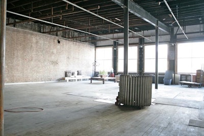Industrial loft exposed beamed ceilings, dark hard wood floors, natural daylight