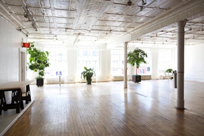 Open soho loft with natural daylight, original hard wood floors and white walls, tin ceiling