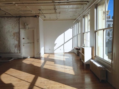 Natural daylight loft with white walls and light hard wood floors and time ceiling