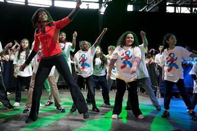 First Lady Michelle Obama leads children exercises during the “Let’s Move! Active Schools” launch