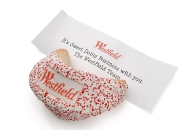 Football-sized chocolate dipped giant fortune cookie with personalized message and logo on fortune