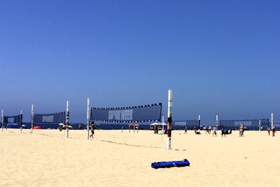 Organizers set up branded volleyball nets along the shores of Hermosa Beach.