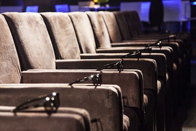 To allow guests the most comfortable experience possible—and anchor the room—a central theater seating area was built for the premiere. Populating it were 175 plush microsuede armchairs, each accessorized with a pair of 3-D glasses.