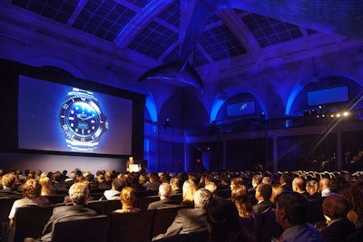 Before introducing his film, James Cameron received the first Rolex Deepsea Sea-Dweller on stage from Arnaud Boetsch, the watchmaker's image and communications director. Additional Rolex branding was present in the monolith walls, freestanding vellum displays, and a 15-foot watch face of the new timepiece projected on the main screen keeping real time.