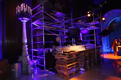 One of the bars for the premiere party was set up directly outside the Edna Barnes Salomon Room. Designed to represent the dark alleys of Gotham—where Bruce Wayne's parents are murdered and where viewers first meet Oswald Cobblepot, also known as the Penguin—the setup included scaffolding, old pallets, metal garbage cans, and acrylic painted to look like junk. Open black umbrellas hung from the scaffolding as a visual cue to the Penguin.