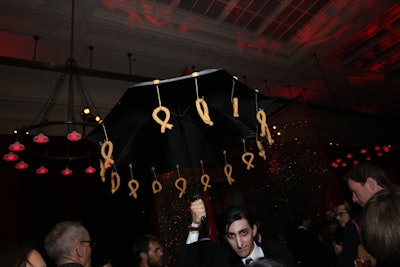 Staffers in black suits and eye makeup also represented the Penguin and during the party passed churros from Pinch that were attached to open black umbrellas.