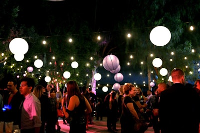 Lanterns decorated Create Nightclub's outdoor patio, where entertainment stations included a Los Angeles Times-branded photo booth, a Flash Tattoo application station, and a fake eyelash bar by Tattoo Kool.