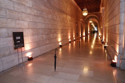 Inspired by the event's invitation—and the Penguin's signature accessory shown in Gotham's first episode—Abel McCallister used black umbrellas to guide guests from the Celeste Bartos Forum, through Astor Hall, and up the stairs to the premiere party in the Edna Barnes Salomon Room on the third floor. To make the freestanding umbrellas stay upright and look like they were balanced on their tips, the producers made clear acrylic bases that were virtually invisible in the dimly lit space. The producers noted that by the end of the night the umbrellas had 'mysteriously disappeared.'