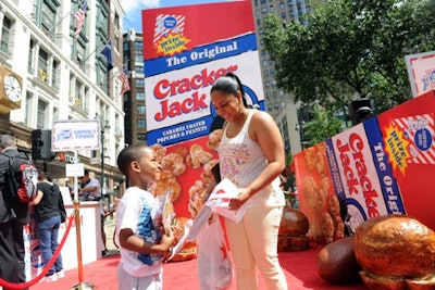 Cracker Jack kicked off its Surprise Inside Project, a nationwide campaign to help individuals pull off small surprises for family or friends, by taking over Herald Square in New York on June 26 with a 15-foot Cracker Jack box, photo opportunities with Sailor Jack, and free samples of the snack.