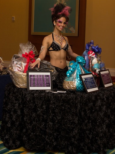 Guests could preview the live auction items on a table dress worn by a scantily clad model from Hardrive Productions.