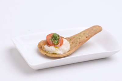Puff ‘n Stuff Catering has several new items on its menu that are easy for guests to eat while standing. The company’s new leek cheesecake, topped with arugula pesto, caramelized onions, and sweet grape tomato, is served in a pesto cracker spoon. There’s also a cold buckwheat crepe stuffed with Brie, red wine-poached fig, and Asian pear slaw, and a mini skewered lobster corn dog with creamy remoulade sauce served in a shot glass.