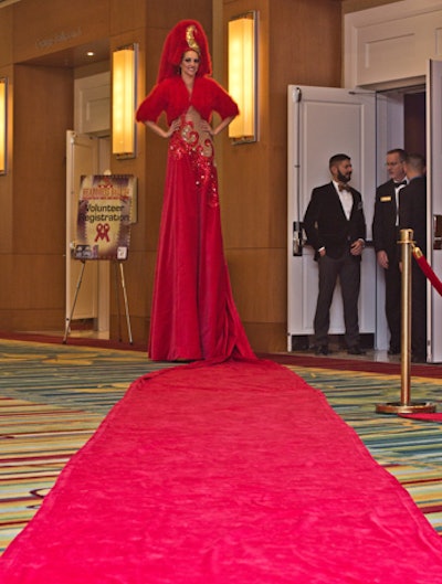 Organizers provided a twist on the traditional red carpet by attaching it to a stilt walker's dress.