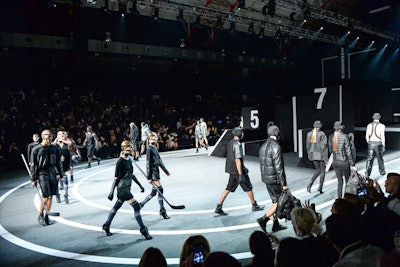 Prodject transformed the Armory's indoor track and field into a fashion arena for a star-studded fashion show that featured such bold-faced models as Tyson Beckford, Karlie Kloss, Isabeli Fontana, and Joan Smalls doubling as Wang's warriors. Prodject customized the track and field lines for the purpose of a fashion show; models walked on grey Astroturf and the audience sat in bleacher-style seating.