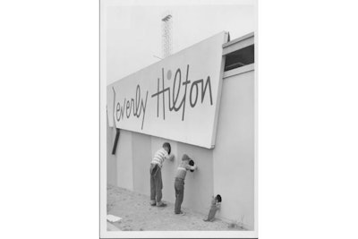 Boys peering through wall