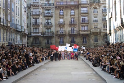 At the conclusion of the show, Chaka Khan's anthem 'I'm Every Woman' played over the sound system as the show's entire cast of 85 models stormed the runway with picket signs ('Tweed we need!' 'Make fashion not war!') and megaphones done in Chanel's quilted leather.