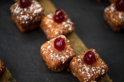 Crispy Parmesan focaccia-coated cheesecake with pesto and olives, served with roasted tomato fennel coulis and Parmesan dust, by Abigail Kirsch in New York