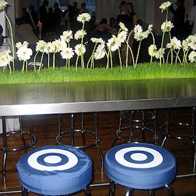 At Target's party to celebrate the fifth anniversary of its work with Michael Graves, bar stools had cushions branded with the bull's-eye logo, and wheat grass and white gerbera daisies decorated steel tables.
