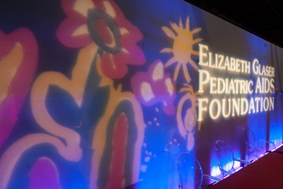 A check-in area featured the nonprofit's colorful logo and clear Ghost chairs.