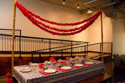 Inspired by India, Kim West of Well Dressed Space used strung lines of red flowers, as well as bowls filled with flower petals, for her table.