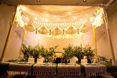 Rebekah Gainsley of Blink Interiors concocted what she referred to as a “Nicaraguan hammock on the beach,” which included a lace canopy with lights and potted greens to resemble hedges.