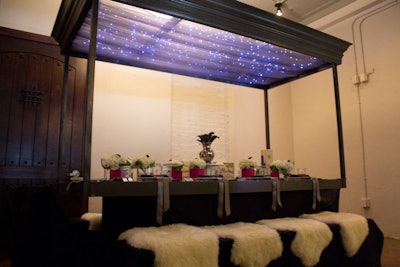 Designer Robin Colton sought to recreate a night under the stars with her table, using a canopy of blue twinkle lights underneath tulle.