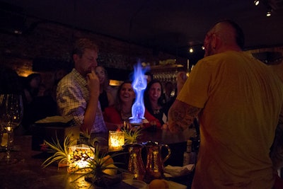 Bartender Dave Schmidt, who also showed off his fire-breathing skills during the event, entertained guests with flaming cocktails.