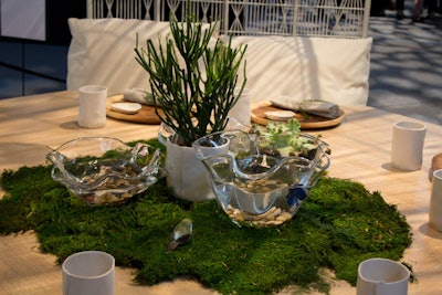 At Diffa Dining by Design's New York iteration in 2013, Kenneth Cobonpue placed plates and cups in organic shapes on a spare wood table. The minimalist setting allowed eyes to focus on the living centerpiece: a cluster of moss topped with bowls that held live Betta fish.