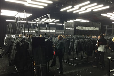 Following the fashion show, guests were given entry bracelets to the pop-up shop built behind the performance stage where they could purchase the collection nearly three weeks before it goes on sale to the public on November 6. The stark, black-and-white setup was straightforward and industrial, with large clothes racks displaying the wares and dozens of fluorescent light tubes hung overhead.