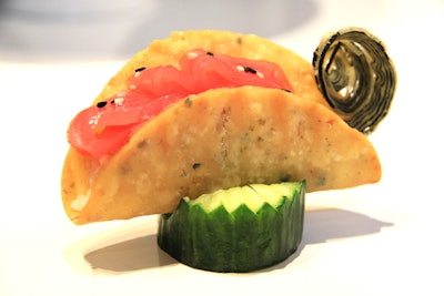 Taco shells made from rice flour and sushi rice, filled with tuna and salmon, and sprinkled with sesame seeds, by Encore Catering in Toronto
