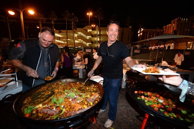 Jose Andres and Bruce Bromberg served attendees from an oversize pan of paella.