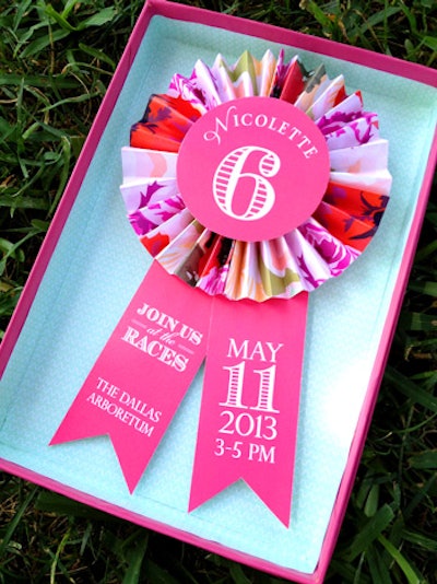 The colorful boxed invitation from Southern Fried Paper puts an artful twist on a racing ribbon. Pricing is available upon request.