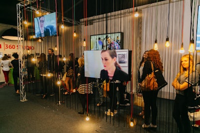 A mix of hanging lightbulbs and string separated the guest queue from the rest of the Canon 360 Studio.