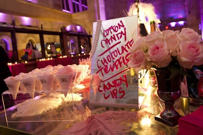 Great Performances decorated the dessert table to look like a boudoir for the opening night after-party for New York City Opera's Anna Nicole production, held at Skylight One Hanson in September 2013. The menu was written in red lipstick on vanity mirrors, and presented alongside jewelry boxes and glass jars filled with chocolate truffles, pink meringues, and candy lips, plus cones of pink cotton candy.