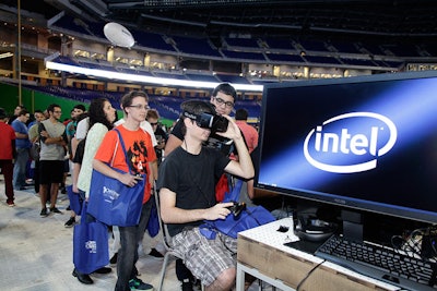 Guests lined up to experience virtual reality from Oculus Rift at Intel's booth.