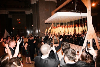 Guests were encouraged to swat the suspended rubber chickens, which were filled with smoked paprika, in order to dust the table lined with deviled eggs below.