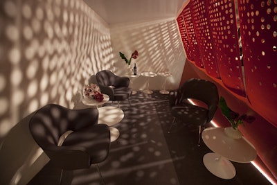 A bright red perforated partition at the Knoll display, which was designed by IA Interior Architects, cast interesting shadows and played into the company’s concept of light, shade, and perspective.