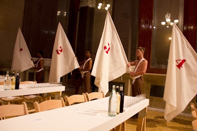 Dinner guests found Renaissance-inspired flag carriers signaling the table numbers.