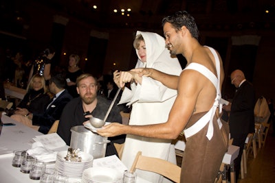 Guests, wrapped in the numbered flags provided by London-based the Old Ladies Rebellion, helped serve soup to their dinner companions.