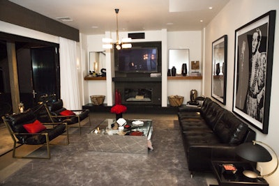 The living room included black furnishings with mirrored finishes and pops of red.
