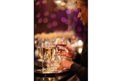Screen shot of a waiter serving champagne at a corporate event.