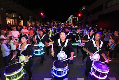 A parade of LED drummers kicked off the grand-opening festival's first night.